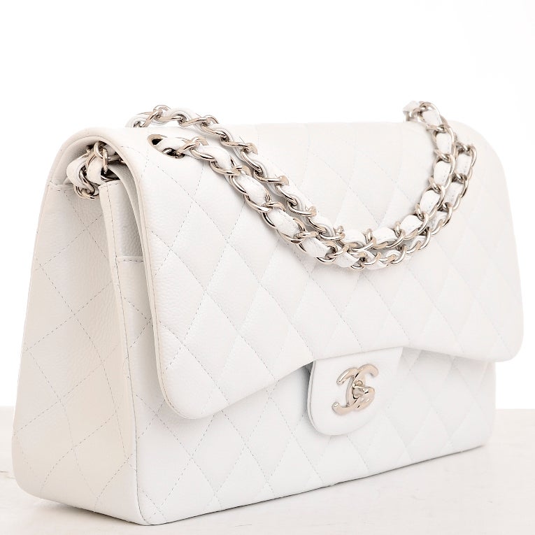 Chanel white quilted caviar leather Jumbo classic 2.55 double flap bag with silvertone hardware, front flap with CC turnlock closure, half moon back pocket and adjustable interwoven silvertone chain link and white leather shoulder/crossbody strap.