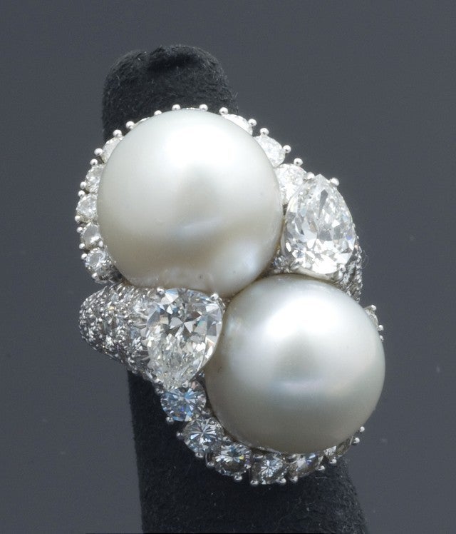 Designed by one of the premier American jewelers, David Webb, this platinum, diamond and South Sea pearl ring is a perfect addition to any important jewelry collection.  The ring features two matching 15mm South Sea, white and two matching
