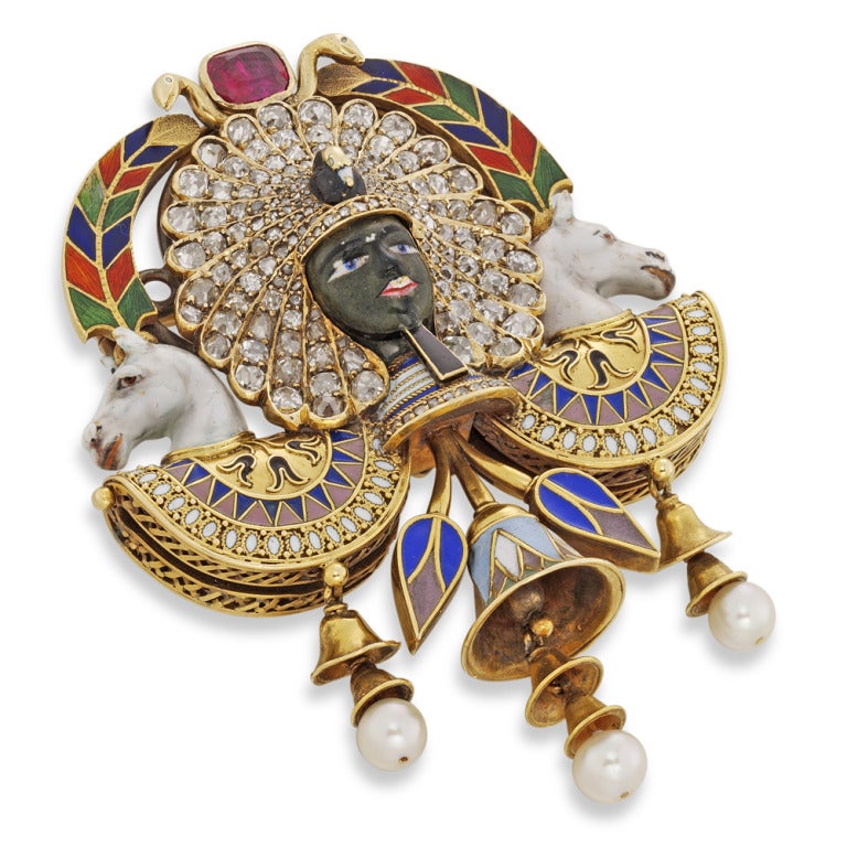 Highly Important Egyptian Revival Pharaoh Portrait Brooch by Carlo Giuliano recognized to be arguably the most significant 19th century Egyptian Revival jewel.

An important Egyptian-Revival Giuliano Pharaoh head brooch, the brooch centred with a