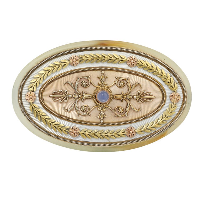 An important Faberge chalcedony, gold and enamel bell push, enamelled translucent blush and pearl grey with sunburst guilloche background, with circular cabochon-cut blue chalcedony pushpiece set within beaded border, varicolour gold arabesques and