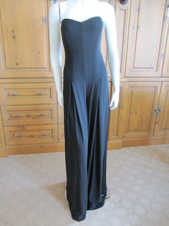 Yves Saint Laurent by Tom Ford sexy black bustier jumpsuit.
It looks like a skirt, but is actually vwey wide leg pant's,,,so elegant,
There is an interior boned corset.
size XSmall, there is a lot of stretch in the fabric
Bust 34