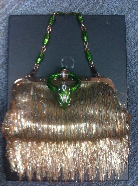 This is an amazing Gucci by Tom Ford bag.
It has enameled green bamboo chain, dragon head, and festooned with gold chain fringe.
It is unused with it's original Gucci tags, priced at $6990