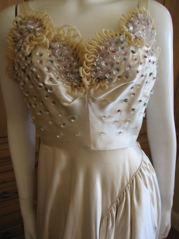 Nina Ricci Haute Couture silk dress with embellishments
This is a wonderful piece, and might make a wonderful wedding dress.
There is a mile of silk in the skirt, and really unusual embellishments on the bust.
Hand stitched, this true haute