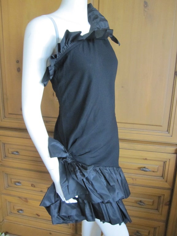 Yves Saint Laurent vintage ruffle one shoulder Little Black Dress
This charming dress has flounces of ruffles at the hem and bustline and bows at the hip and shoulder.
It is marked sz 38, but seems to run large
Bust 39