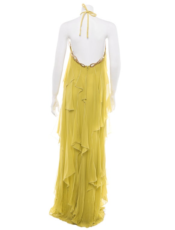 Emelio Pucci exquisite silk chiffon gown with golden chain trim


This charming dress has flounces of chiffon  and gold rope trim embellishment at the bust.
The chain detailing is detachable for cleaning, it snap's on to the dress.

New with
