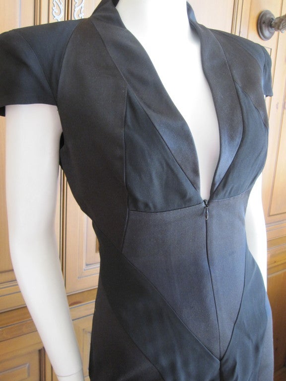 Alexander McQueen black satin sheath dress with mandarin collar, structured cap sleeves chiffon panels throughout and zip closure at front.


Measurements: Bust 32