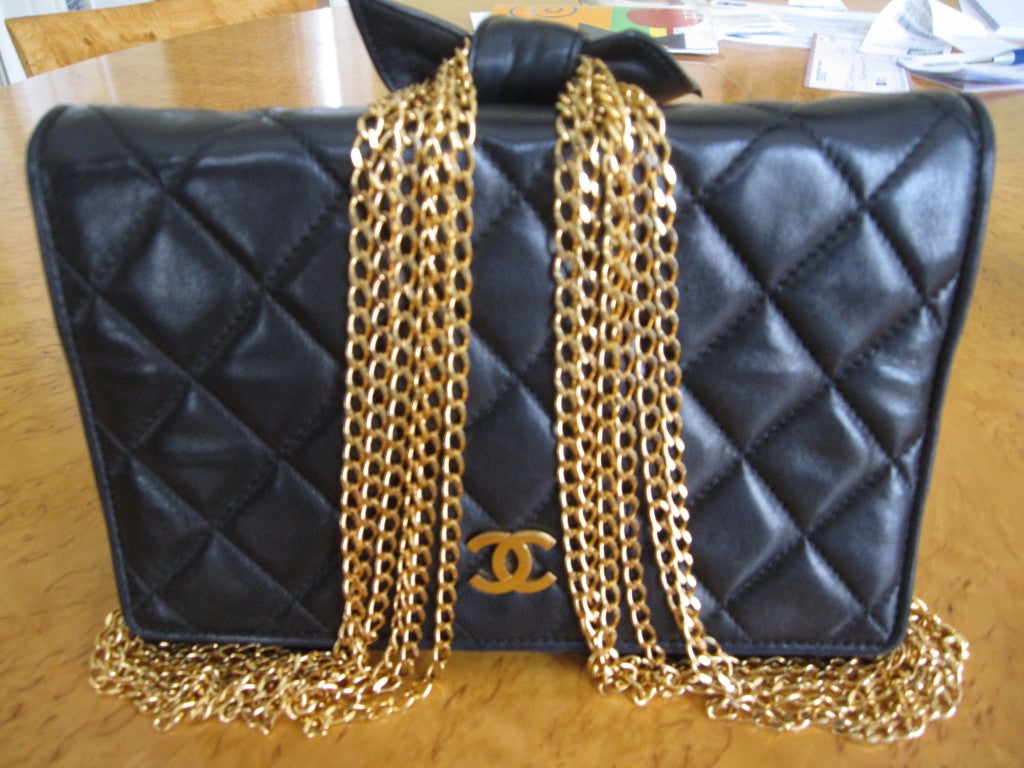 Chanel unusual vintage classic black quilted flap bag with bold gold chains & leather bow

 Height 5