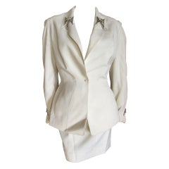 Thierry Mugler crisp white suit with four bold jewels