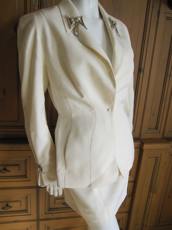 Thierry Mugler crisp white suit with four bold jewels 1