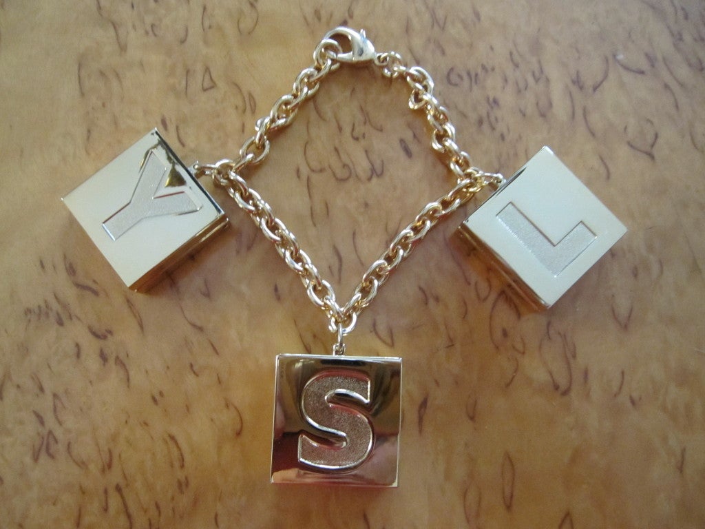 Women's Yves Saint Laurent charm/compact bracelet  New in Box