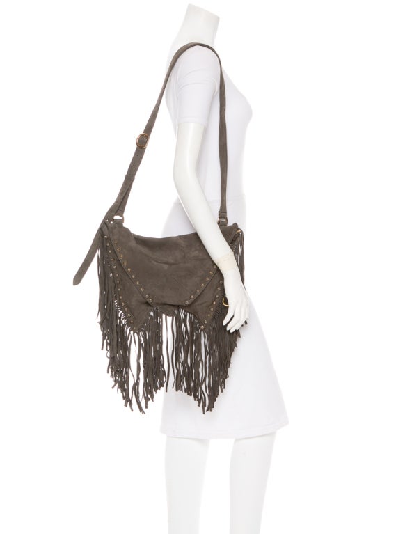 Chrome Hearts boho chic gray suede fringe bag.
 Grey suede shoulder bag with fringe along bottom trim, sterling silver hardware, one interior zip pocket and triangle flaps at front and back. 

Shoulder Strap 37?, Height 11?, Width 15?, Depth 1?