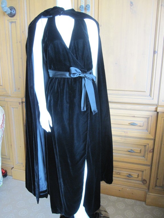 Mollie Parnis Madame X black velvet wrap dress with matching floor length cape.
Black cotton velvet.
Sz 8.
Because it is a halter style wrap dress, it will fit many different sizes