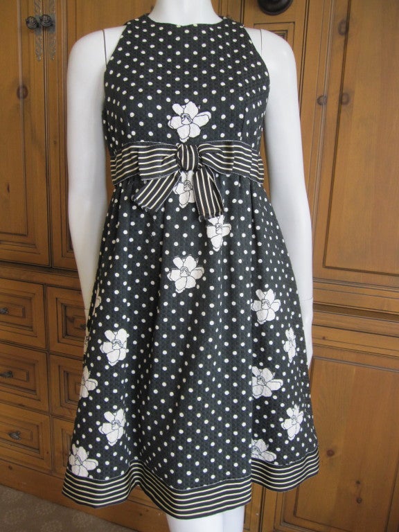 Geoffrey Beene 1960's A-line babydoll dress.
This early Beene has all the DNA that are Geoffrey Beene hallmarks;
white dots on a black background, contrasting stripes, white flowers, and bows.Beautifully finished, the inside is lined in sheer