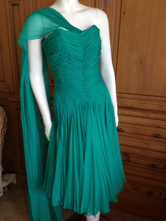 Jean Desses emerald green pleated silk chiffon dress.
The handwork involved to create all the patterns in the pleating is remarkable.
This Jean Desses was designed in Paris, and made, in the same fine fabric, in the US by Nanty.
In those days the