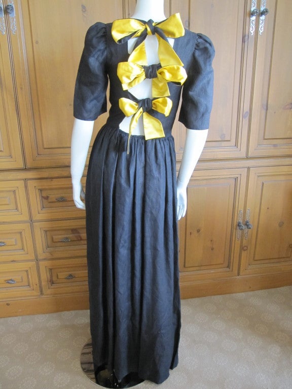 Lanvin vintage 70's silk backless tie silk dress with tags.
Unusual backless dress with bold ribbon ties.
Fully lined in golden yellow silk, the outer layer is black woven silk.
With it's original tag from the Beverly Hill's Lanvin boutique