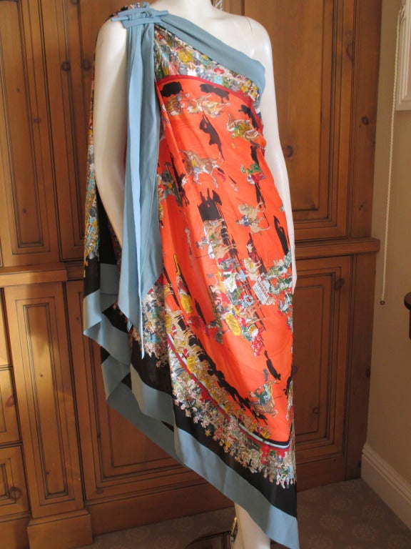 Hermes by Jean Paul Gaultier Spring 2011 Silk Mousseline one shoulder scarf wrap/dress with an enamel metal clip that matches the blue trim.
The print is 