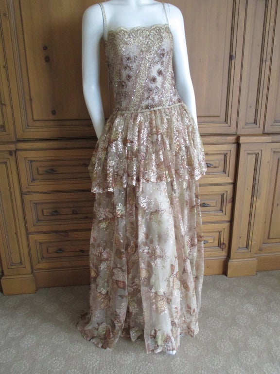 Nina Ricci Haute Couture Sheer Gold Lace Evening Dress
Circa 1970's ?
The top is fully boned over the sheer netting.
Inside the skirts are sheer skintone pant's