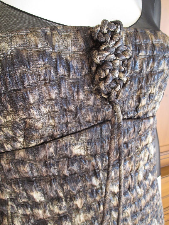 Ralph Rucci Feather Trim Quilted Alligator Pattern Dress.
This is so exquisite. The silk is quilted in to an alligator pattern. There is a sheer top, plunging very low in the back. Accented by knot details and trimmed on the hemline with two types