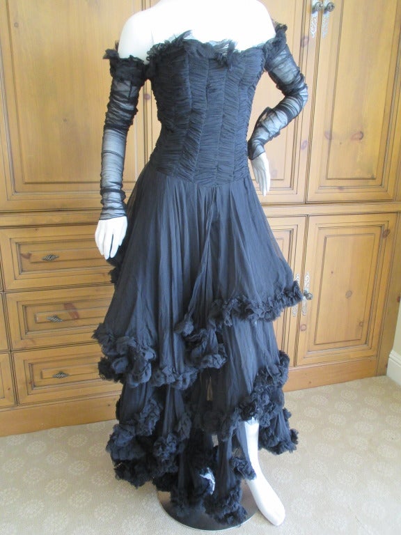 Alexander McQueen F' 2002 Dramatic Black Dress.
Exquisite goth confection from the Fall 2002 collection.
Interior boned corset.
Shown on the runway in blush with a leather harness.
This is in black with no harness.
The sleeves are