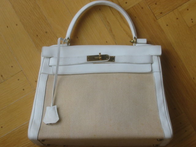 Hermes Vintage Canvas and Leather Kelly Bag<br />
<br />
This lovely bag is made of white leather and canvas. It has gold hardware and the signature Kelly clasp.<br />
<br />
The bag has been gently used and there are faint signs of wear.Please