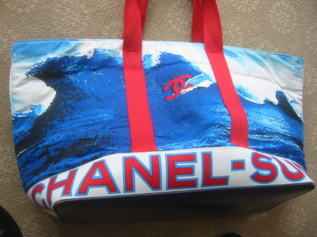 Chanel Huge Surf Collection Beach Bag<br />
<br />
This fabulous beach bag is made of thick cotton with a print of a large wave with the CC logo riding a surfboard. The bag has sturdy thick straps. The interior is lined with a plastic waterproof