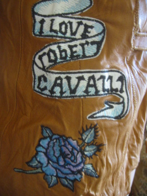 Unusual Hippy chic 70's retro styled embroidered jacket from Roberto Cavalli.<br />
Intentioally distressed to look like a 70's hippy deerskin jacket, but tricked out with many unusual details;scrunched elbows, split sleevs with hok eye closures,