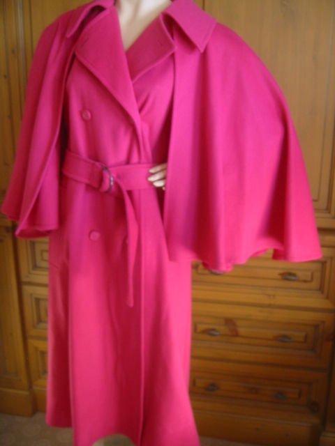 Wonderful hot pink coat with Cape from Yves Saint Laurent.<br />
This is a heavy weight wool, perfect for the cold winter, and not for the shy.<br />
You'll be noticed in this.<br />
Sz 36 but seems to run very large<br />
Bust 44