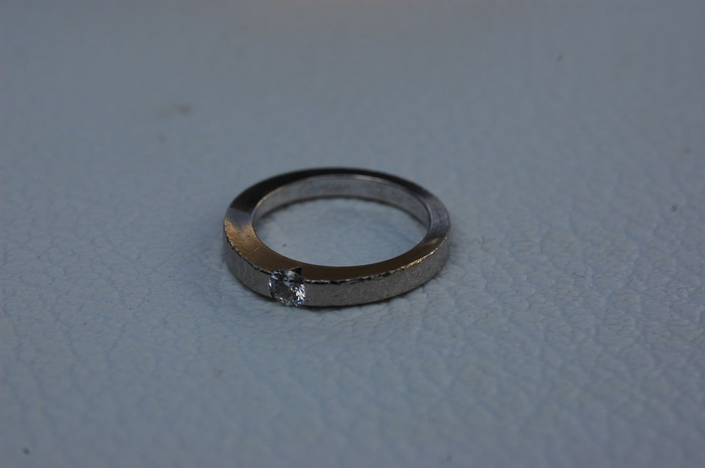 Tension Set 18kt white gold ring from Cartier<br />
Appx .21 ct diamond<br />
G0ld weight 3.5 dwt  5.4 grams<br />
style stamped 52 # C216356<br />
Quite well worn and abraded<br />
apx 7.5