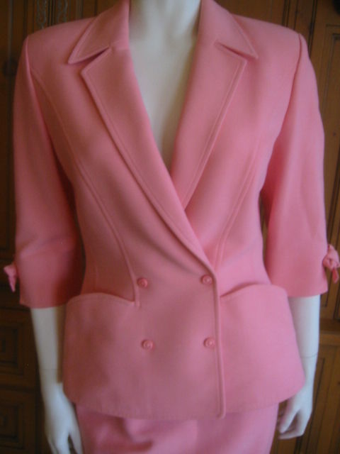 Elegant bubblegum pink suit, from the master tailor , Thierry Mugler.<br />
Known for his precision cut, and dramtic details, this suit features bracelet length sleeves with bows, and an exagerated hip, a mugler signature.<br />
Suits are one of