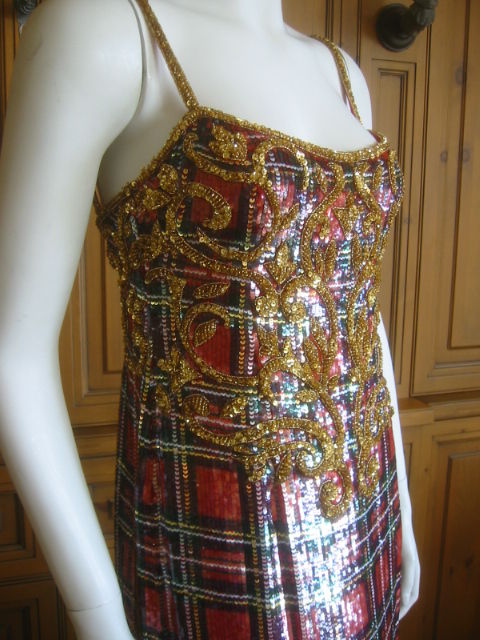 Escada Couture Scottish Plaid sequin dress.<br />
This is such an interesting piece, Baroque pattern bead work over Sequined Scotch plaid.<br />
Fully lined in red silk<br />
<br />
Sz 36<br />
<br />
Bust 33