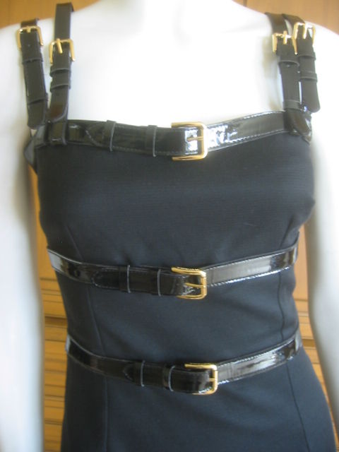 Dolce & Gabbana Sexy Little Black Dress with Patent Leather Bondage Straps.<br />
This is such a rockin piece, fully lined in Dolce signaturel Leopard print silk.<br />
Sz 40 (seems to run small)<br />
Bust 33