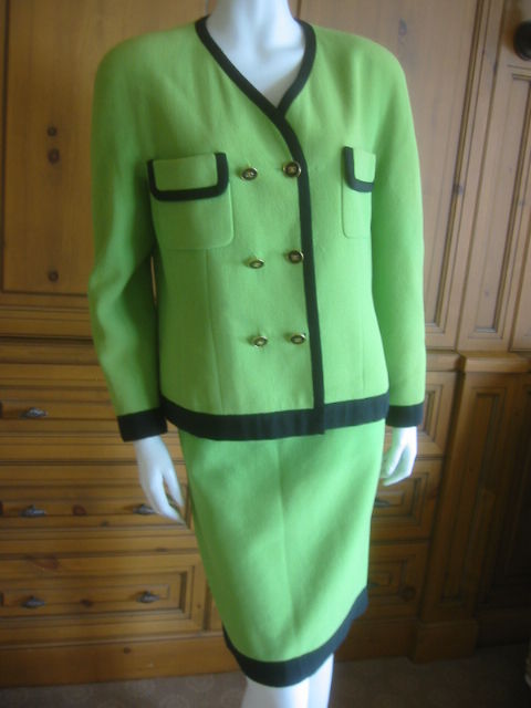Chanel charming vintage neon green suit with black trim.<br />
This is such a charming piece, really vivid acid green.<br />
Fine Green wool, lined in the same green silk CC lining.<br />
Black grossgrain ribbon trim<br />
Sz 42<br />
<br