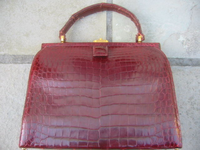 Wonderful burgundy alligator Doctor's satchell from Lucille de Paris.<br />
Founded in Paris in the late 30's Lucille made quality exotic skin bags, which were de rigueur for women of a certain class.<br />
They moved operations to NY during the
