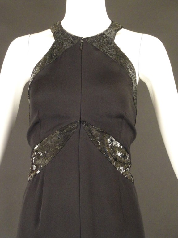 Gorgeous 1990s Evening gown in a black silk crepe and in a larger size! The gown has a scoop neckline with a center front zipper closure. The gown has gorgeous seaming with sequin panels that slim the body through the waist and hips and into the