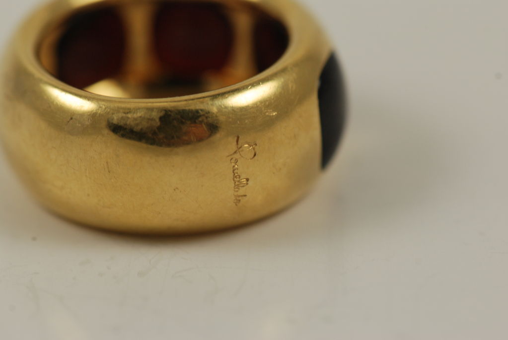 Heavy 18k yellow gold and cabochon garnet ring by the Italian maker Pomellato. Stones go across the front of the ring. Ring is size 6 1/2. Ring may be sized somewhat.