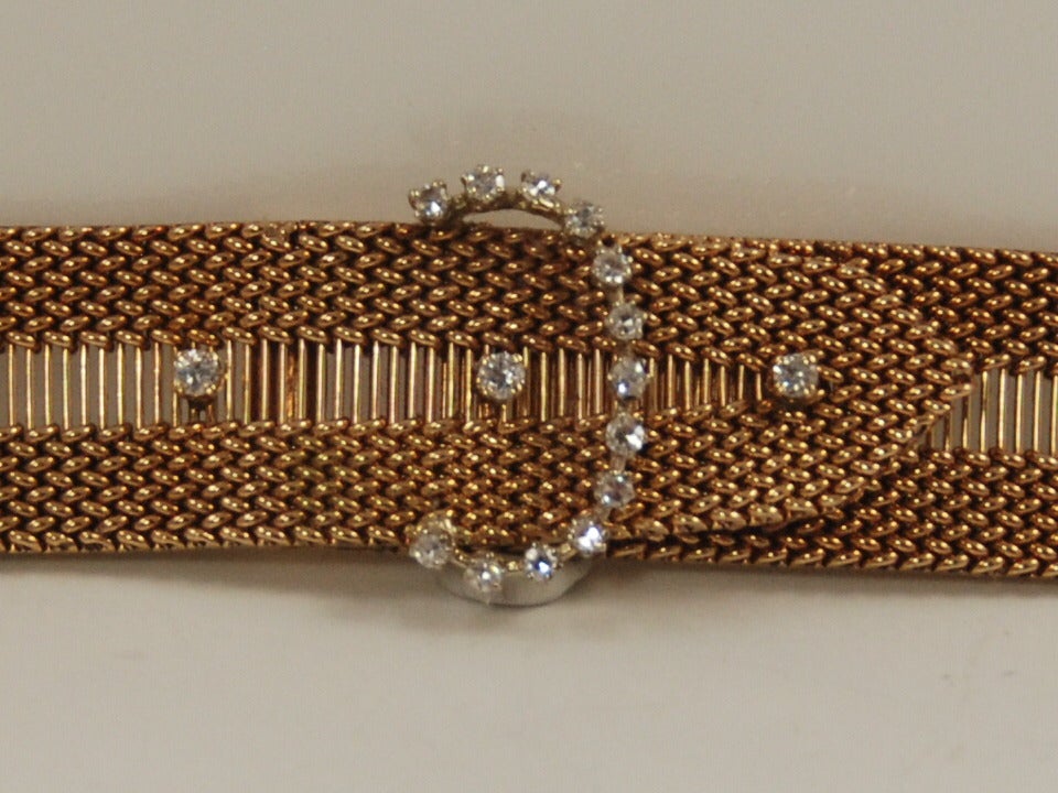 Yellow gold and diamond retro mesh buckle bracelet from the 1940s.  Bracelet closes in the rear with a box clasp. Having the type of closure makes the bracelet easy to put on and take off. There are two safety clasps. The front of the bracelet has