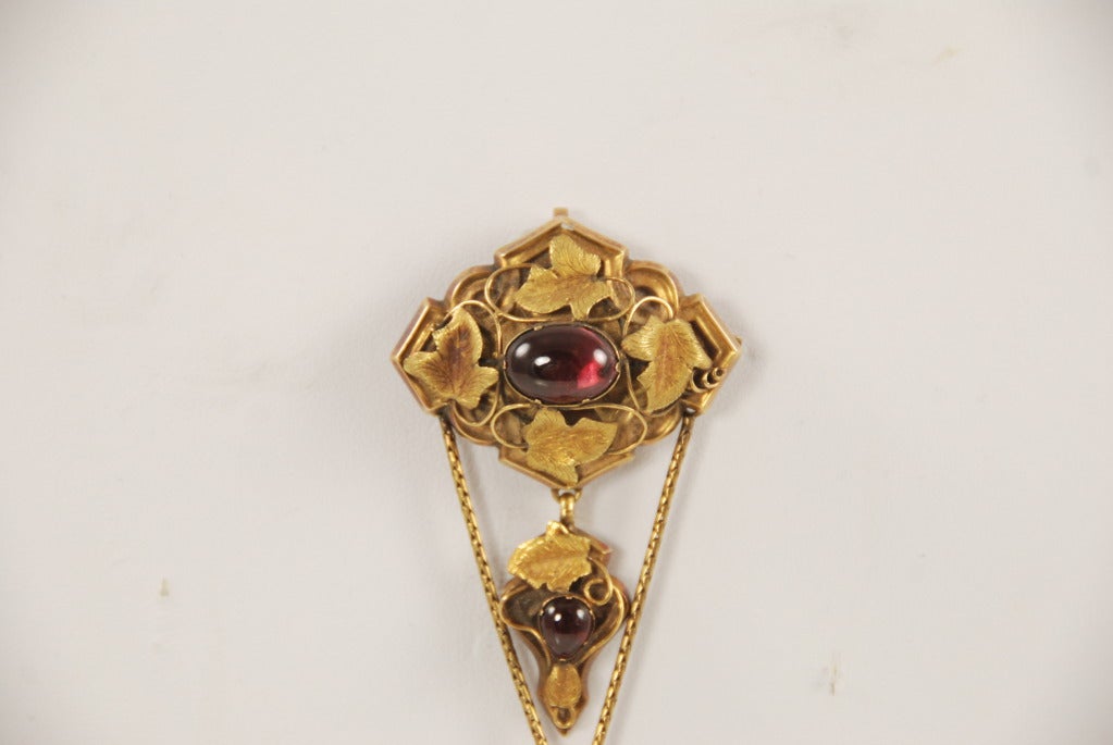 Art Nouveau 14k gold and cabochon garnet brooch/pendant with This fascinating piece of jewelry comes apart so it can be worn many ways. There is a bale so it can be worn as a pendant and the pin back has a 