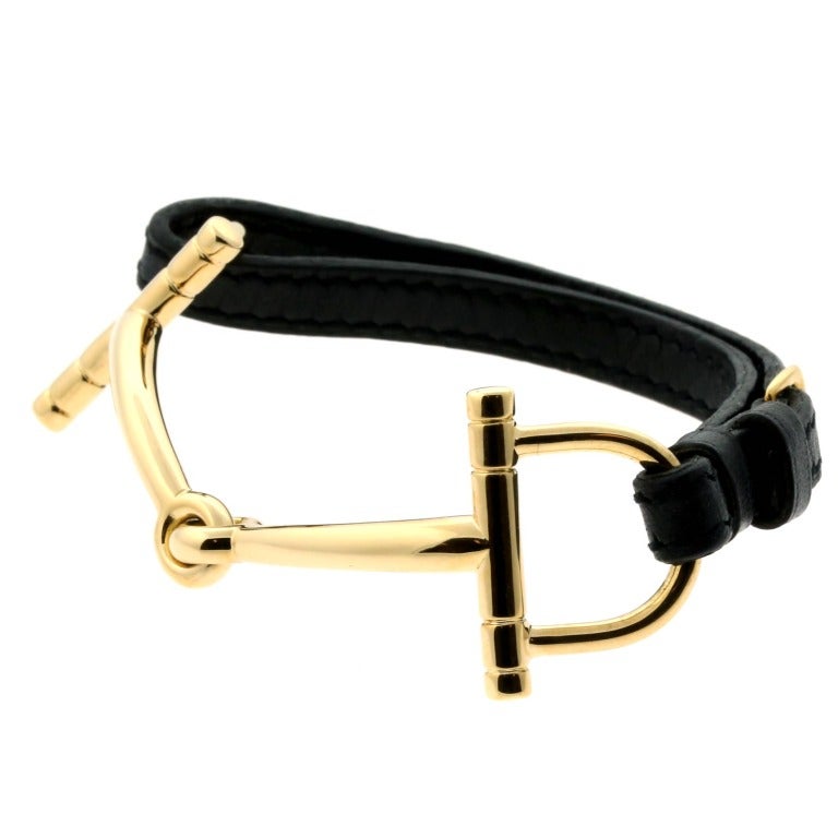 This very rare Hermes bracelet features an 18k Yellow Gold Snaffle Bit design on a leather strap. The leather strap is adjustable and has a total length of 7 inches. The Snaffle Bit motif has a length of 81mm (3.18″ Inches) by 24.5mm wide (.96