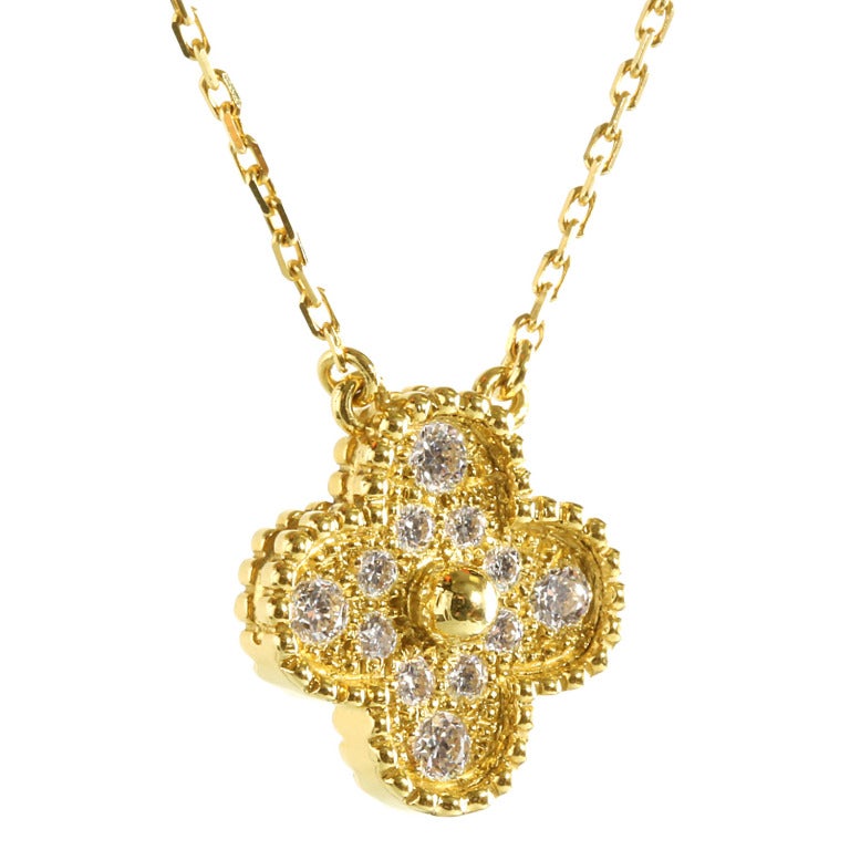 This symbolic Van Cleef & Arpels Alhambra necklace is from the Vintage Alhambra collection and is internationally recognized. The necklace is crafted out of 18k Yellow Gold, and features 12 VVS1 E Color Round Brilliant Cut Diamonds. The Alhambra