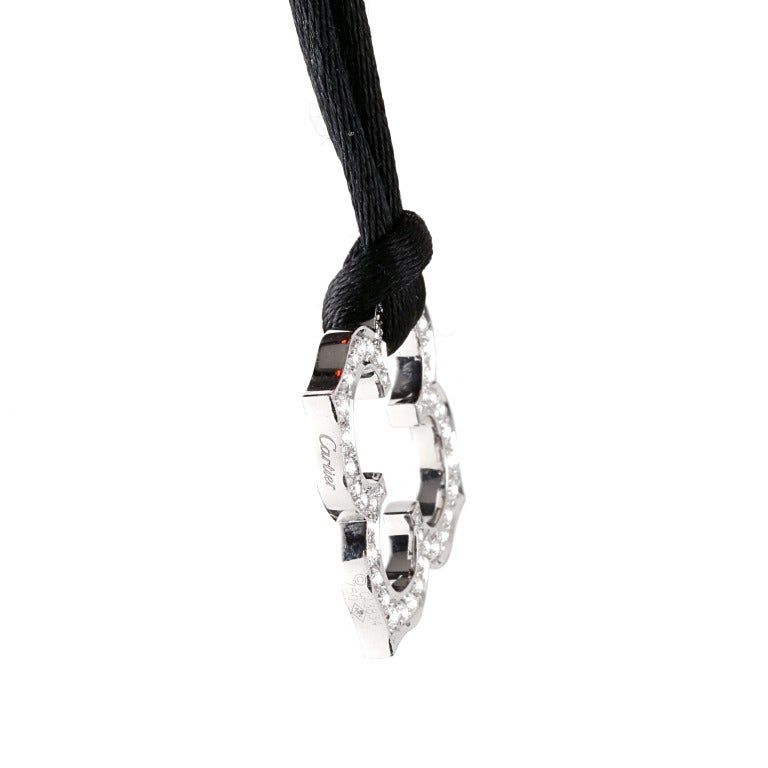 This very rare Cartier C's necklace features an 18k White Gold Pendant which is set with VVS1 E Color Round Brilliant Cut Diamonds suspended on a Cartier Silk Necklace. The pendant measures 1.16 Inches wide, and the necklace may be worn at any