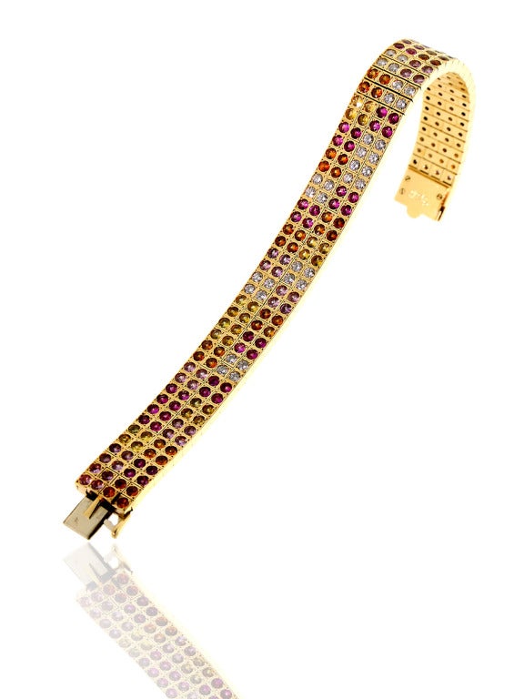 Simply sensational: there’s no better way to describe this extravagant 18k Yellow Gold bracelet by Cartier, which features 184 Multicolor Sapphires and 28 Diamonds immaculately placed throughout the band to maximize the aesthetic appeal. This