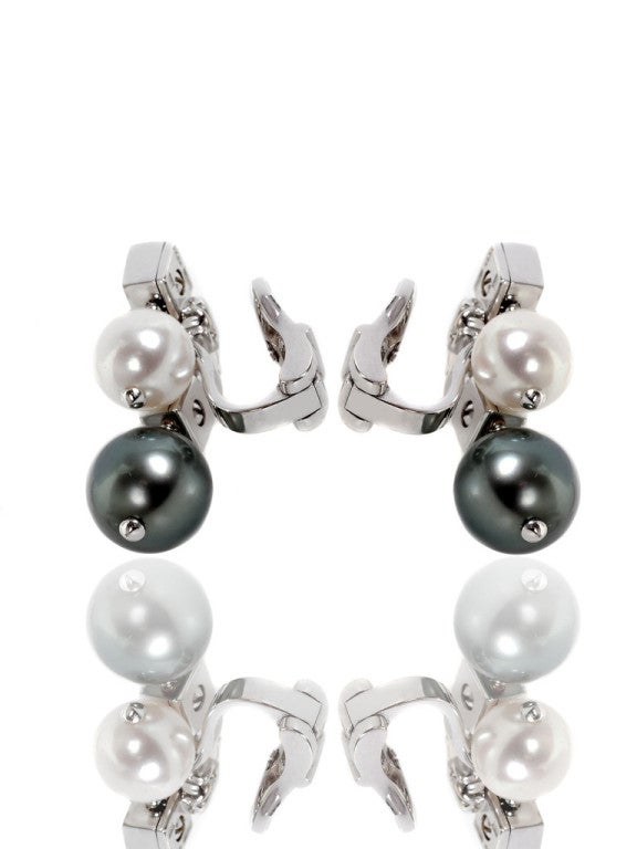 Bulgari Lucea earrings featuring 16 E-F Color Vs1 Round Brilliant Cut diamonds followed by 4 pearls; 2 white pearls which are 5mm and 2 black pearls which are 7mm each. The earrings measure 15mm wide (.59