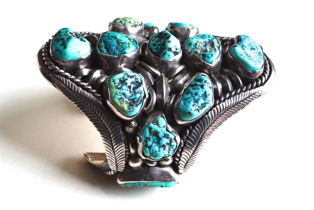 Outstanding Navajo Native American turquoise cuff.  I believe it to be by, Jimmy Victor Begay, circa 1970s. From an Arizona collector's estate. The bracelet has thirteen turquoise nuggets, signed JVB. Interior length is approximately 2.5″ across. 