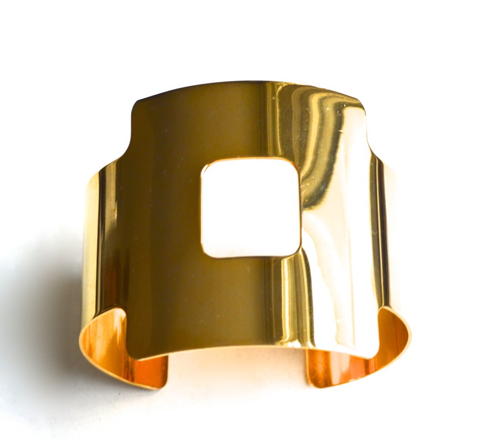 Rare 1960s-70s golden metal signed Givenchy armband/cuff. The design is that wonderful mod futuristic style made so popular during this time. The armband is in excellent condition with mild surface wear overall, no major scratches to the finish. The
