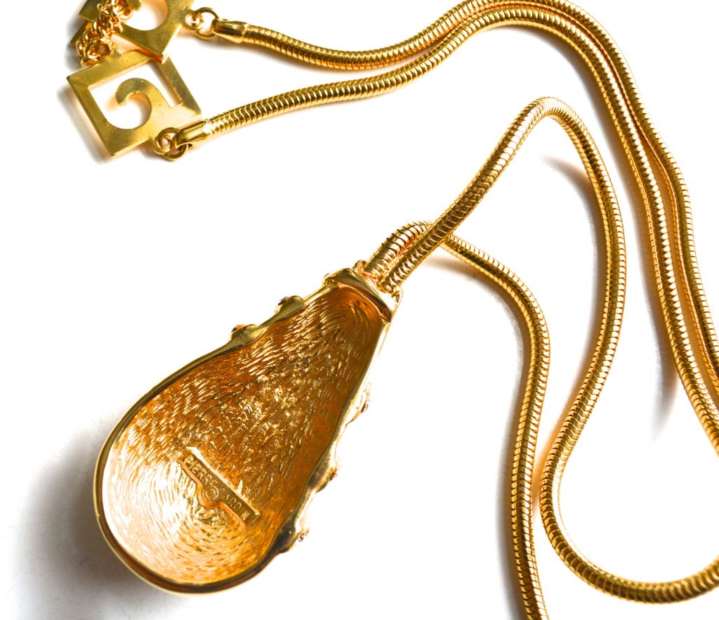 Gilt metal 1970s-early 80s mod drop pendant, signed Pierre Cardin.  Longer versatile chain. Pendant is 1.5″ wide X 2″ L.