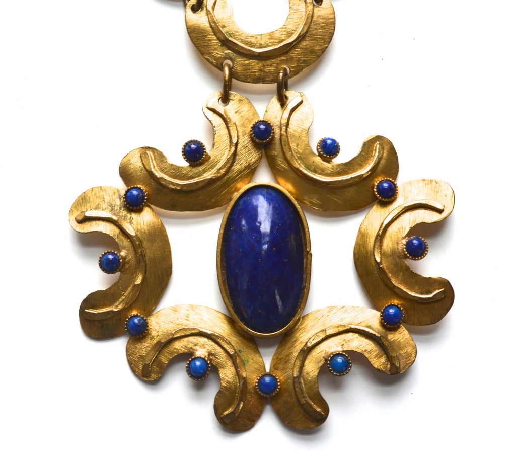 Mid century Italian art glass and metal work necklace. Width varies. Pendant drop, 3″L. Stamped “Silvana Made in Italy.” The piece has great and unique construction with very pretty lapis blue glass details.