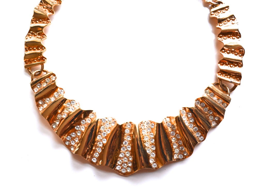 Golden signed Givenchy ripple necklace with rhinestone accents. The surface of this piece and texture is truly stunning. Circa 1980s.