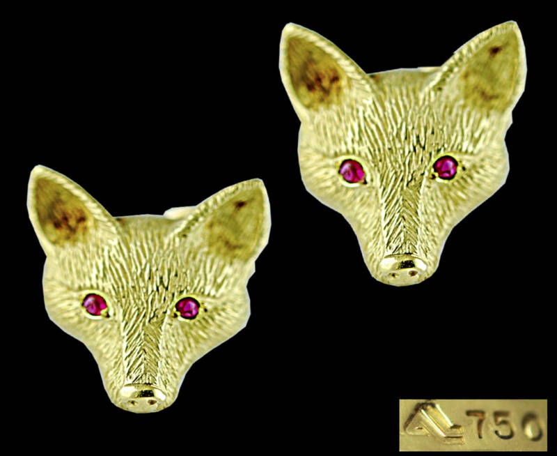 Being offered is a pair of fine 18 karat gold and ruby ear clips - earrings - one-of-two-made - by Albert Lipten, of New York, in a most realistic form -- the motif of a fox head -- with ruby (2 mm each) eyes. Weight 14.8 grams.  Dimensions 13/16
