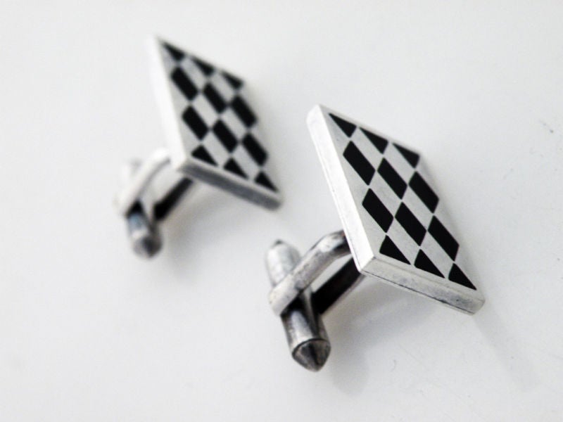 Being offered are a fine pair of circa 1955 sterling silver and obsidian cufflinks designed by Antonio Pineda, of Taxco, Mexico. Each cufflink measures 1 inches long by 5/8 inches wide. The diamond pattern - harlequin motif - is superb.  Pineda