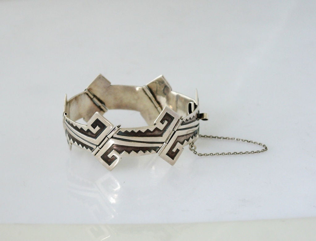 Being offered is a fine circa 1960 sterling silver bracelet by Pedro Castillo, of Taxco, Mexico; handmade bracelet, diagonally aligned Aztec motif links with deliberate oxidation; tongue & box closure with safety chain. Dimensions: 1 1/4 inches